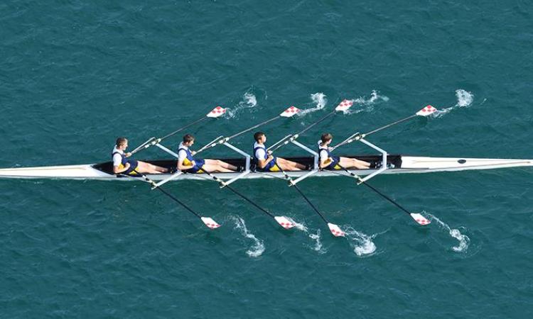 Four men rowing.