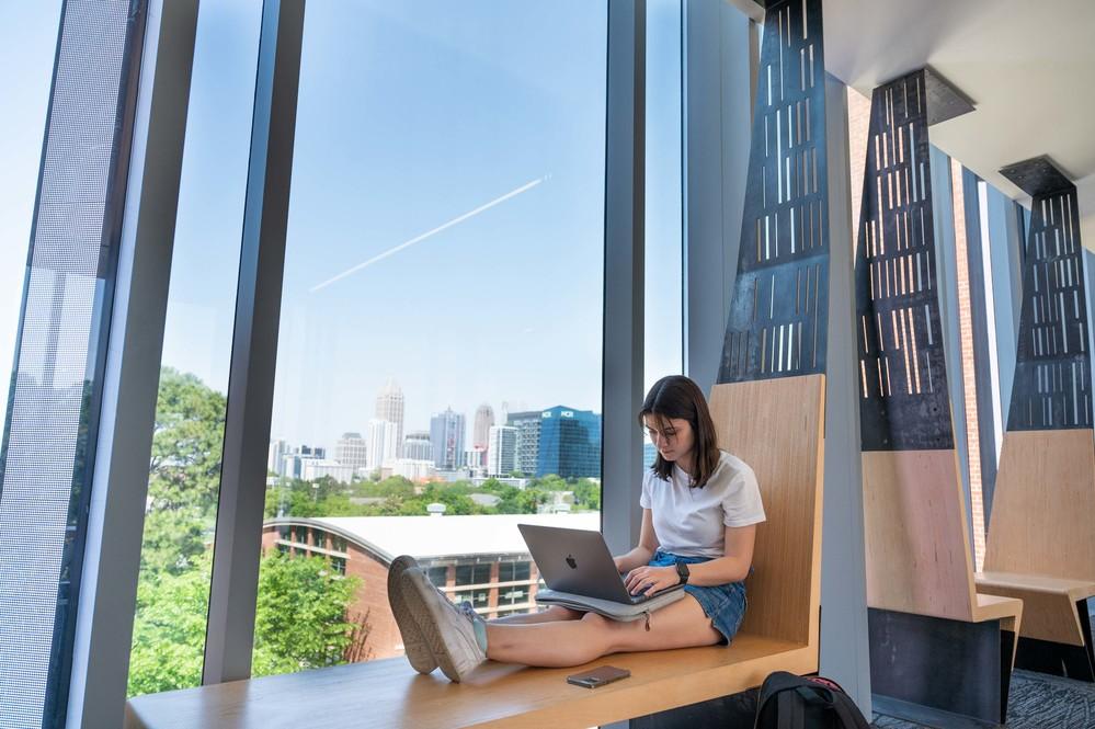 A student studying by a window.