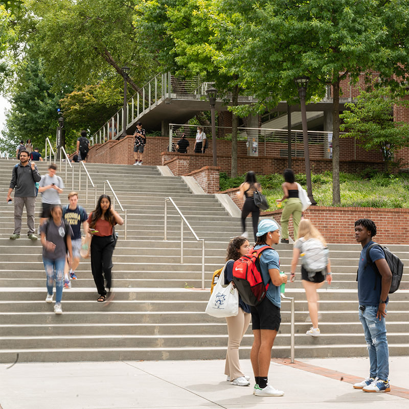 Georgia Tech students walking up an down campus stairs.