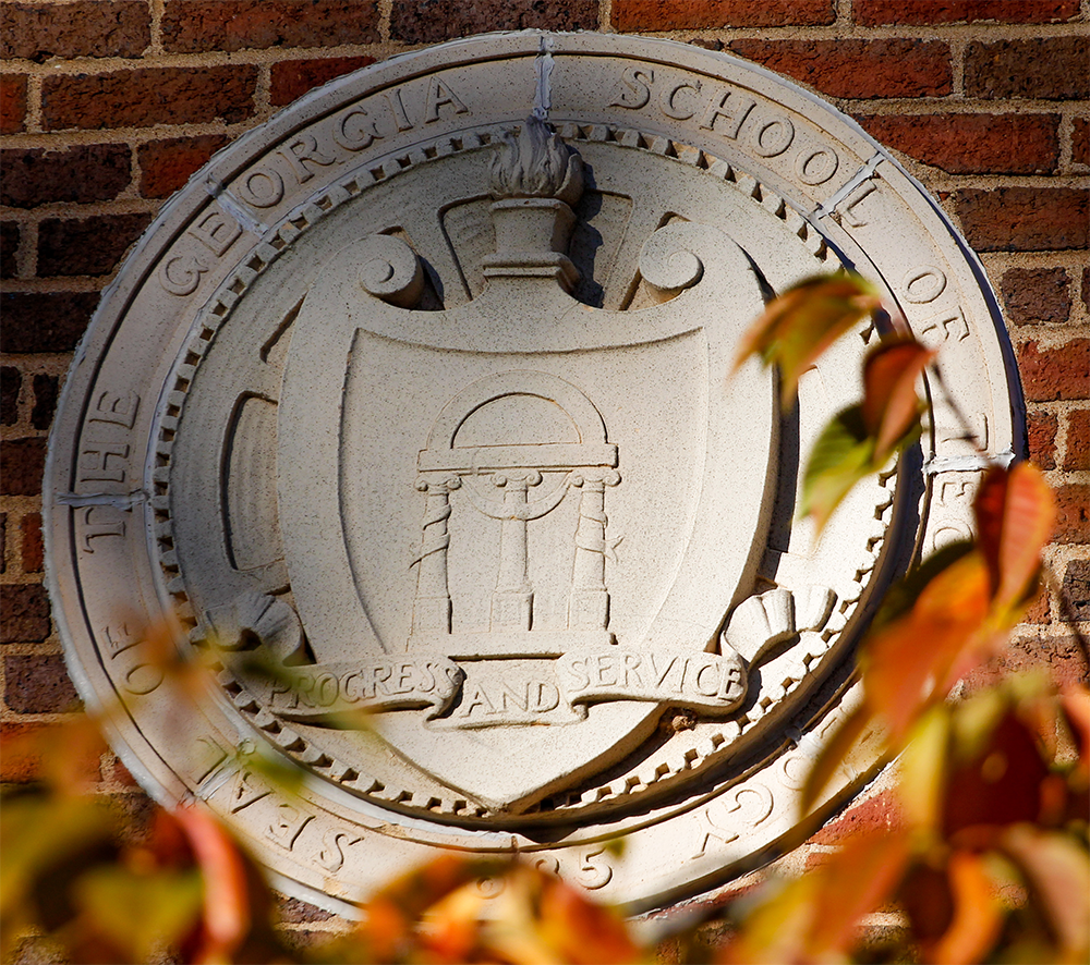 Georgia Tech stucco relief medallion that reads: Seal of the Georgia School of Technology. Progress and Service.