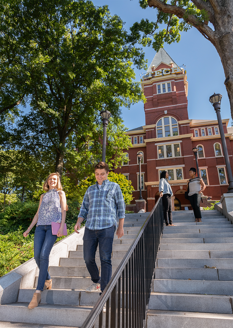 Tech students walk and talk at the stairs in front of Tech Tower.