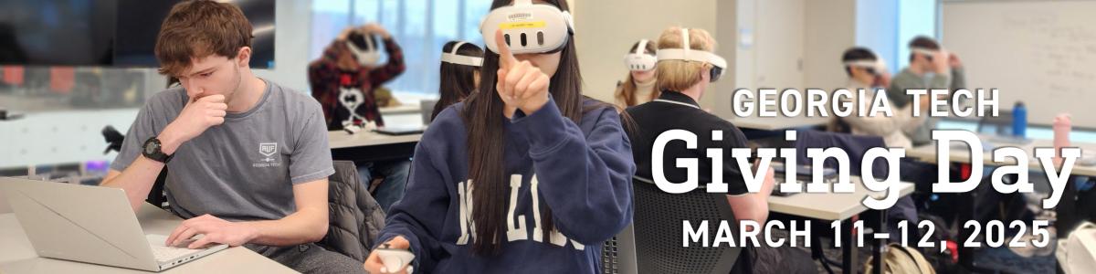 A group of students in a classroom. Some are wearing VR headsets; some are looking at their computers.