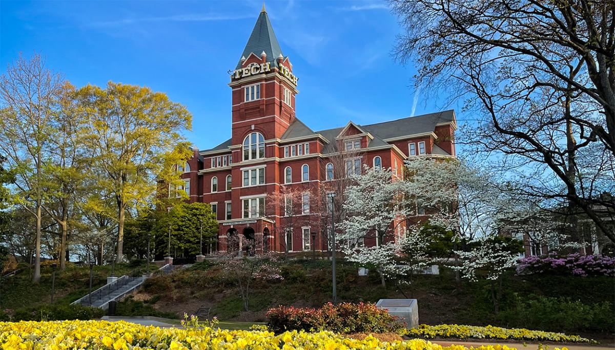 Tech Tower surrounded by flowers and blooming trees.